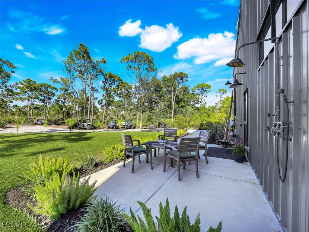 4412 Pinetree Boulevard St. James City, FL 33956 - Photo 44 of 50 a view of a patio with table and chairs and potted plants