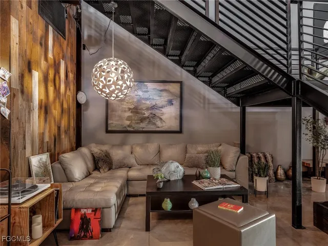 a living room with furniture and a painting on the wall