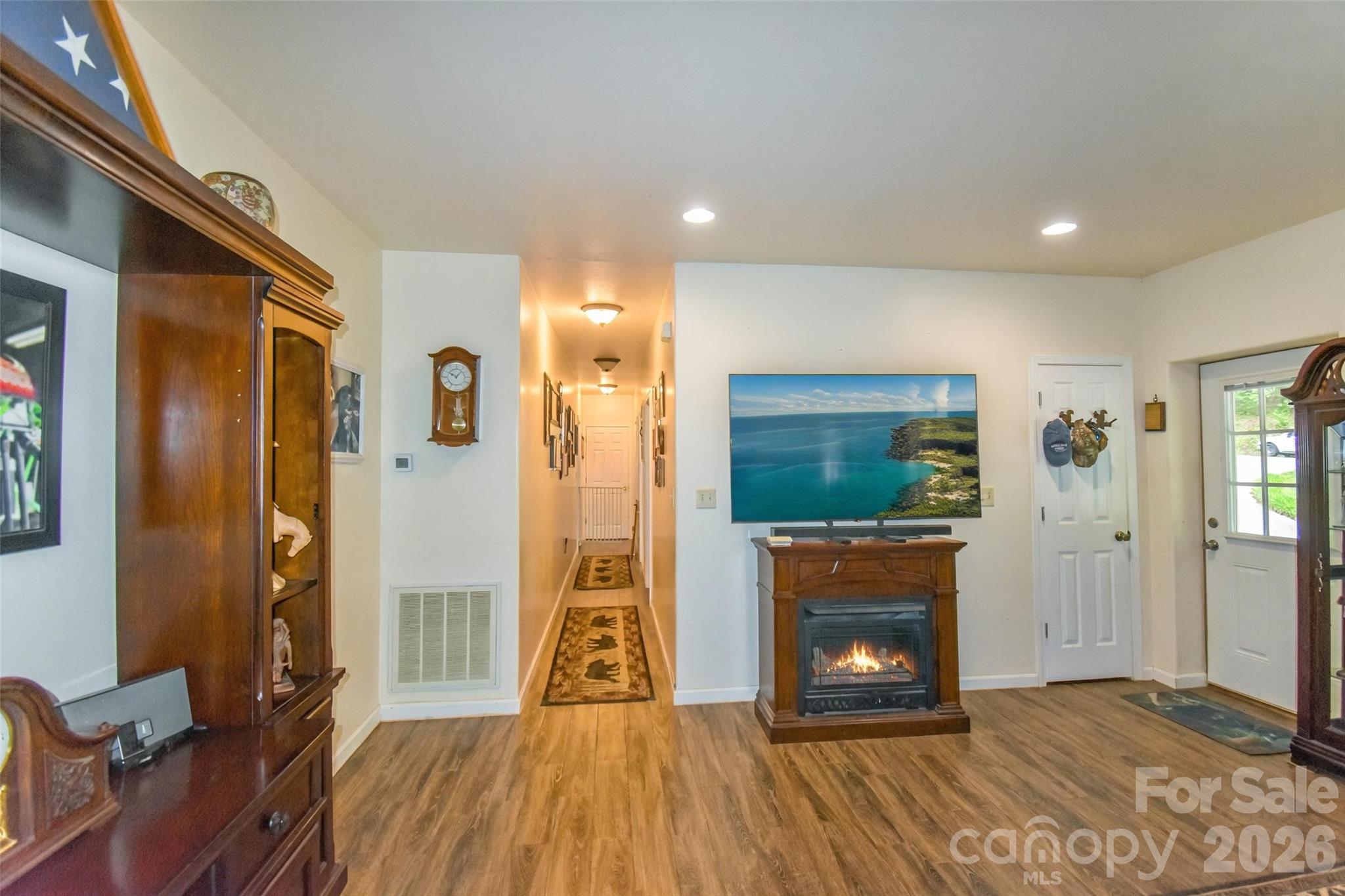 945 North Country Club Road Brevard, NC 28712 - Photo 17 of 42 a view of a livingroom with wooden floor a fireplace and entryway