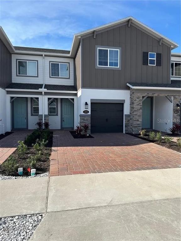 a front view of a house with a yard and a garage