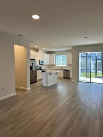 a view of kitchen with furniture and wooden floor