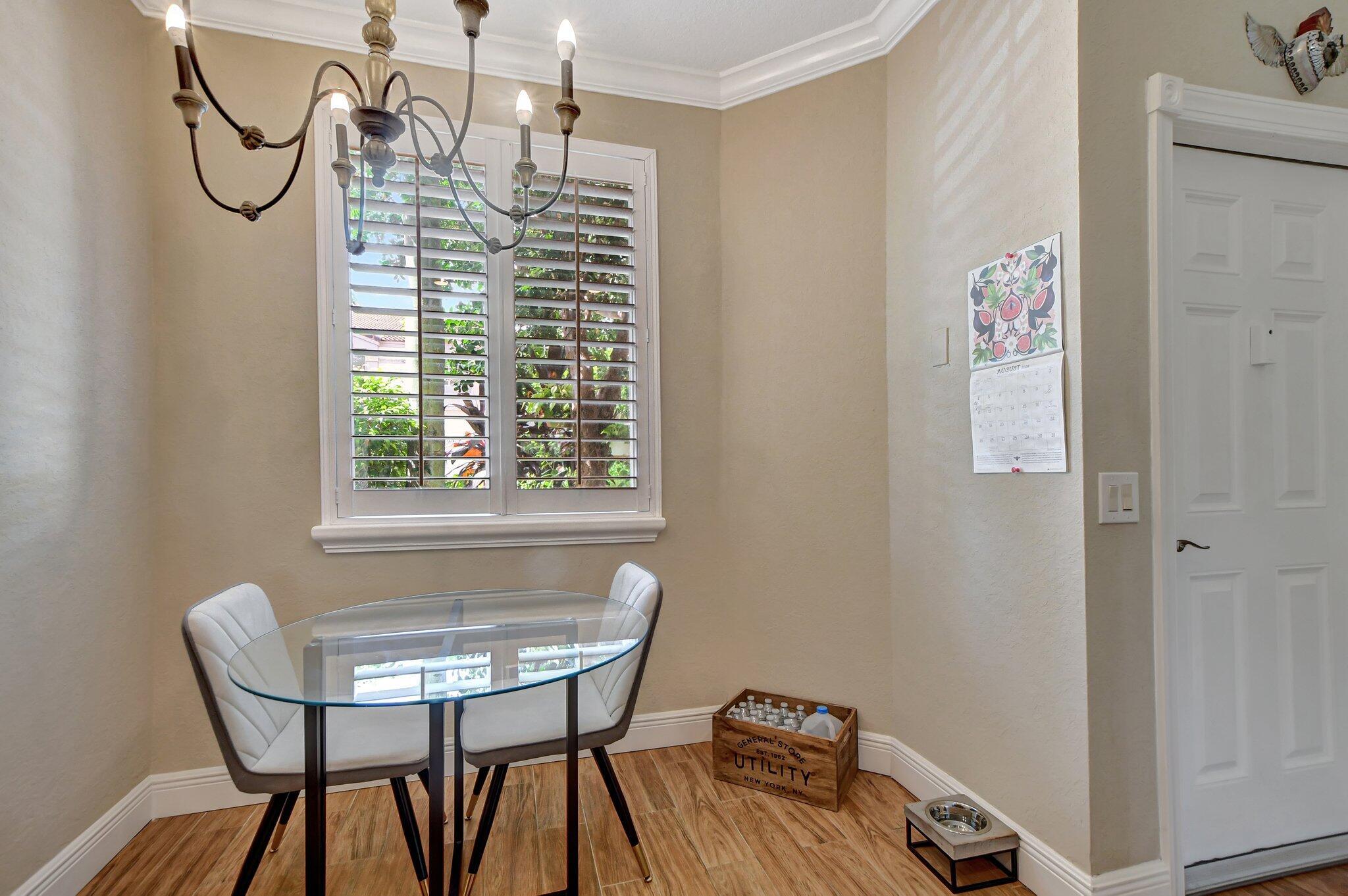 6682 Via Regina Boca Raton, FL 33433 - Photo 8 of 46 a view of a dining room with furniture and a window