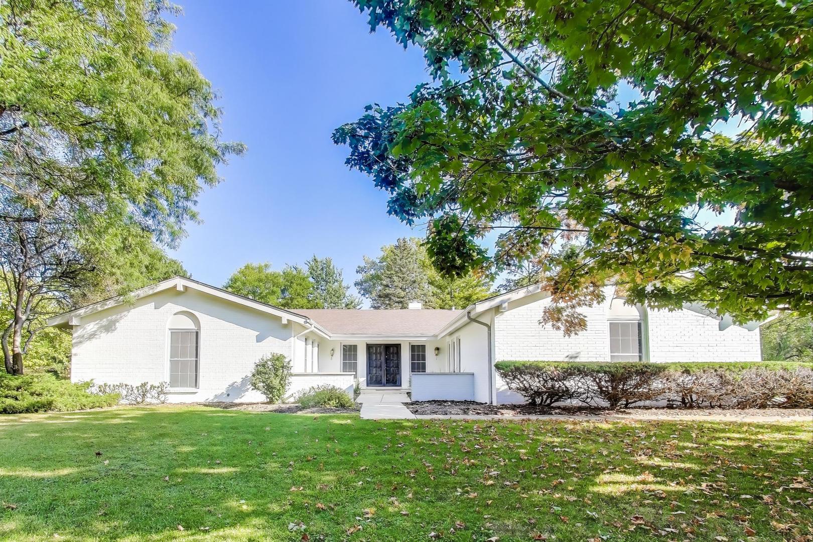 a front view of a house with a garden and yard