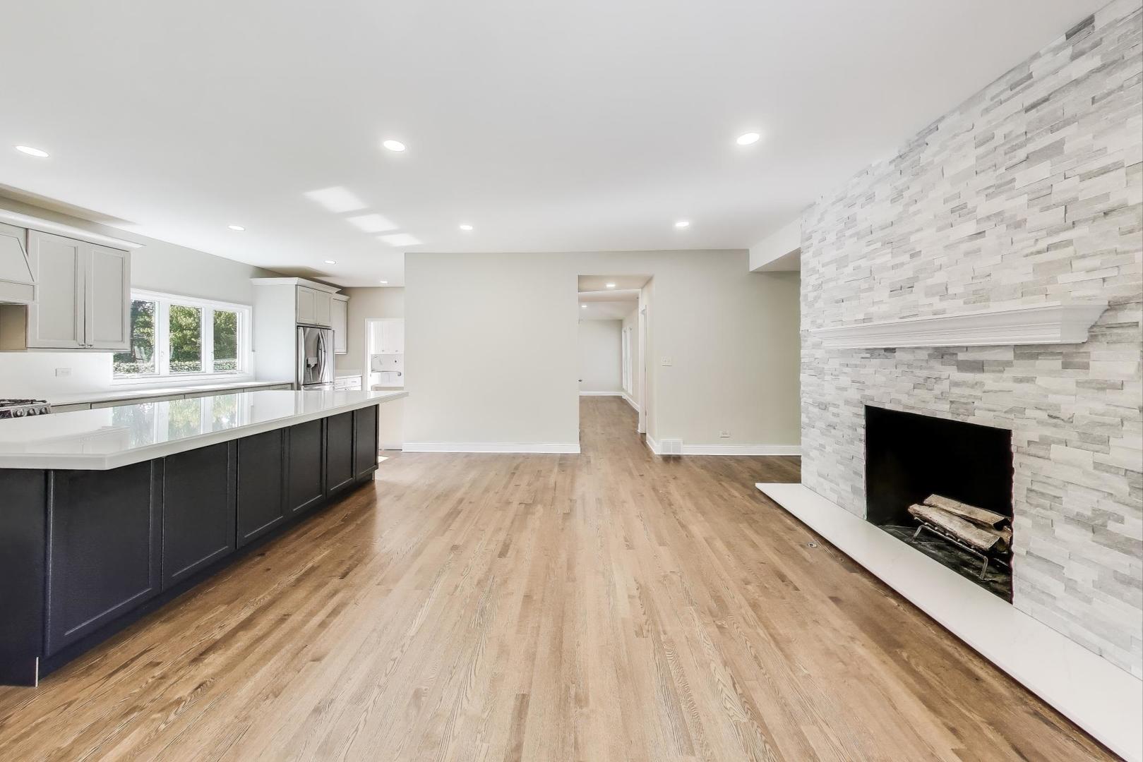 1627 South Ridge Road Lake Forest, IL 60045 - Photo 17 of 30 a large white kitchen with a sink and dishwasher a fireplace with wooden floor