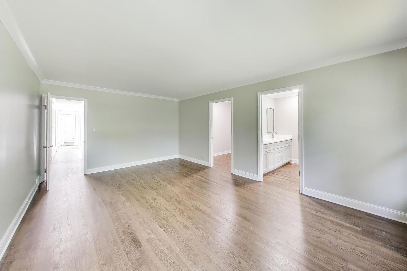 1627 South Ridge Road Lake Forest, IL 60045 - Photo 20 of 30 a view of an empty room with wooden floor and window