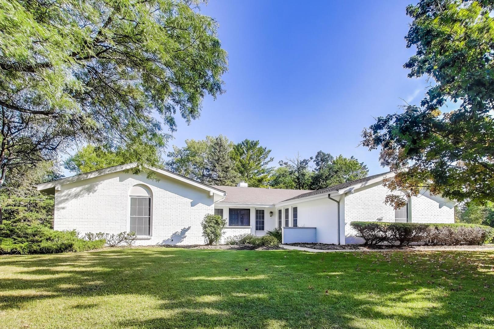 1627 South Ridge Road Lake Forest, IL 60045 - Photo 2 of 30 a front view of a house with a garden and trees