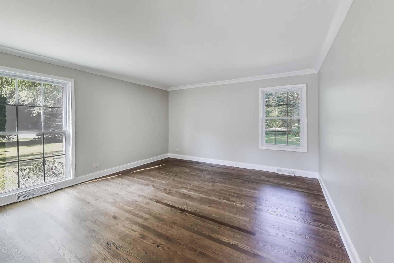1627 South Ridge Road Lake Forest, IL 60045 - Photo 8 of 30 an empty room with wooden floor and windows
