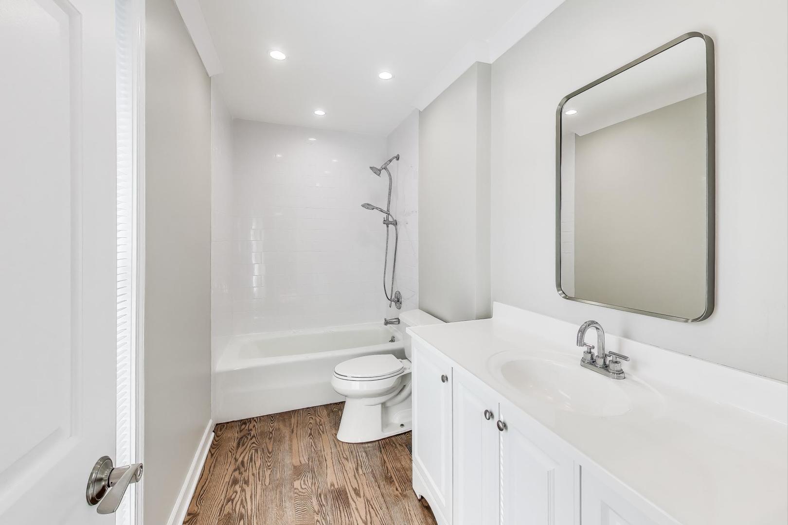 1627 South Ridge Road Lake Forest, IL 60045 - Photo 9 of 30 a bathroom with a bathtub shower sink vanity and toilet