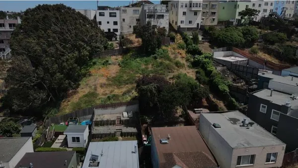 an aerial view of multiple houses with yard