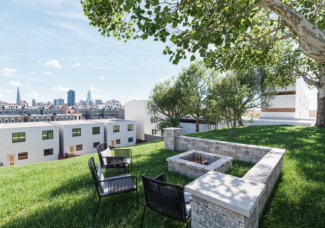 a view of a chairs and table in the back yard of the house