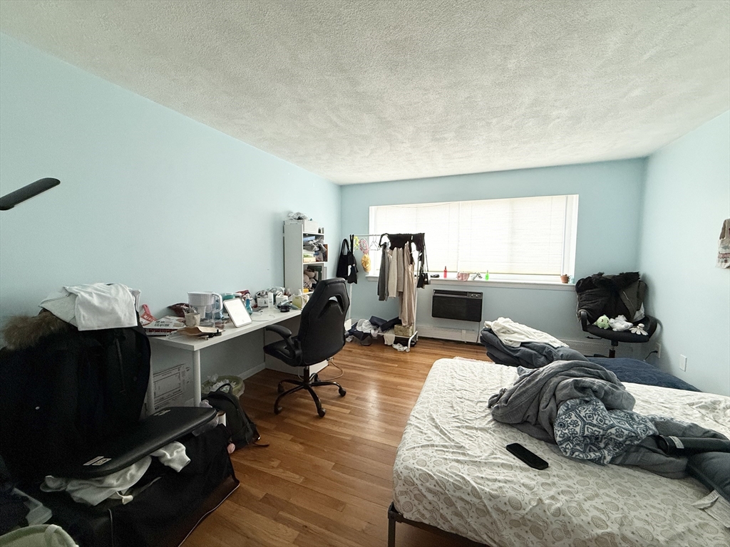 20 Radcliffe Road, Unit 206 Boston, MA 02134 - Photo 11 of 13 a living room with furniture window and a wooden floor