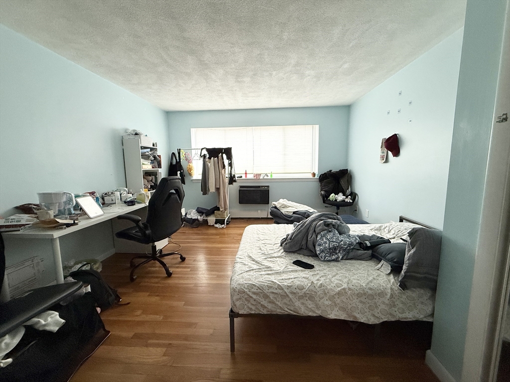 20 Radcliffe Road, Unit 206 Boston, MA 02134 - Photo 12 of 13 a bedroom with furniture and a wooden floor