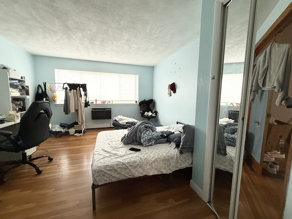 20 Radcliffe Road, Unit 206 Boston, MA 02134 - Photo 13 of 13 a bedroom with bed and wooden floor