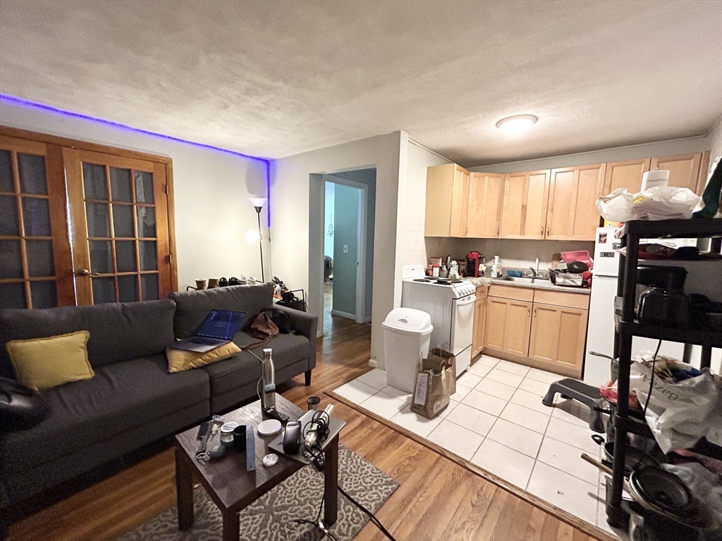 20 Radcliffe Road, Unit 206 Boston, MA 02134 - Photo 2 of 13 a living room with furniture and a dining table with kitchen view