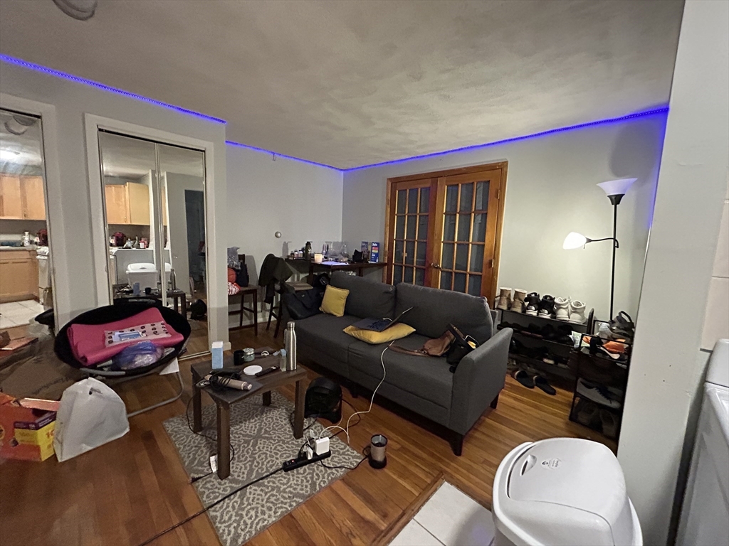 20 Radcliffe Road, Unit 206 Boston, MA 02134 - Photo 3 of 13 a living room with furniture and wooden floor