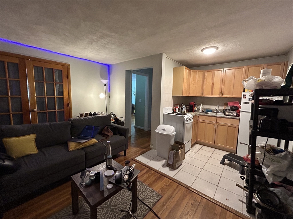 20 Radcliffe Road, Unit 206 Boston, MA 02134 - Photo 5 of 13 a living room with furniture and a large window