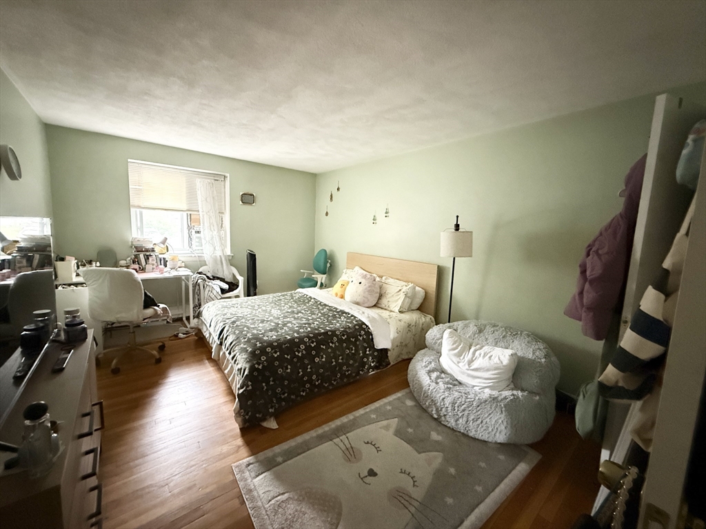 20 Radcliffe Road, Unit 206 Boston, MA 02134 - Photo 6 of 13 a bedroom with two beds and wooden floor