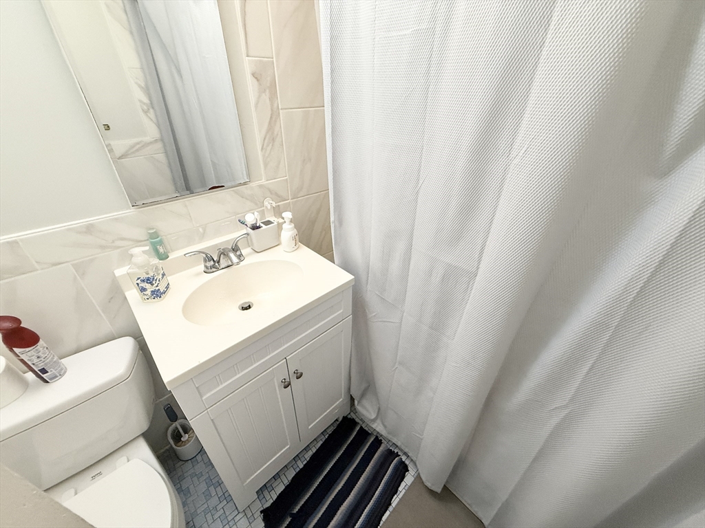 20 Radcliffe Road, Unit 206 Boston, MA 02134 - Photo 9 of 13 a bathroom with a sink and a mirror