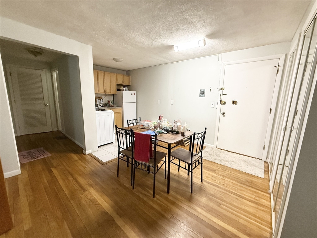 20 Radcliffe Road, Unit 206 Boston, MA 02134 - Photo 10 of 13 a view of a dining room with furniture and wooden floor