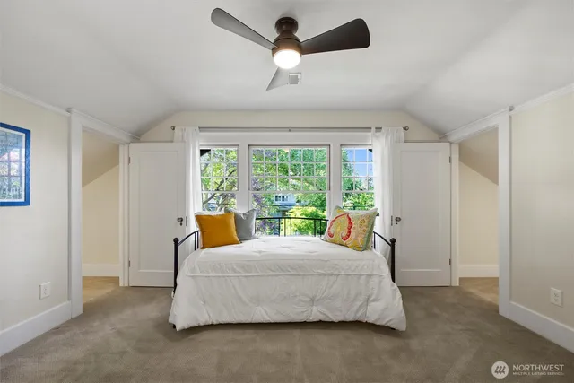 a bedroom with a bed window and couch