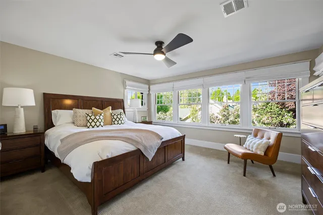 a spacious bedroom with a bed and a large window