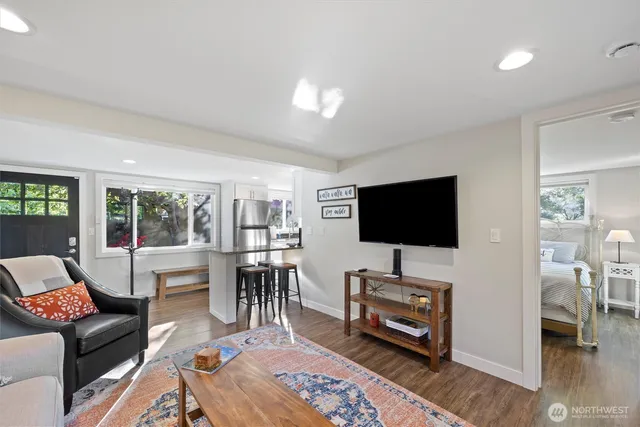 a living room with furniture and a wooden floor