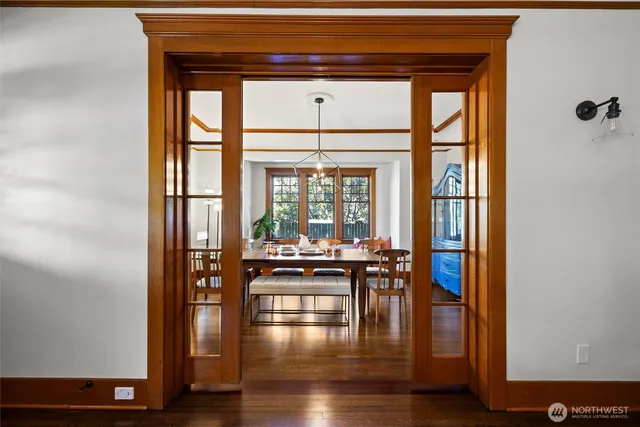 a dining room with furniture and wooden floor