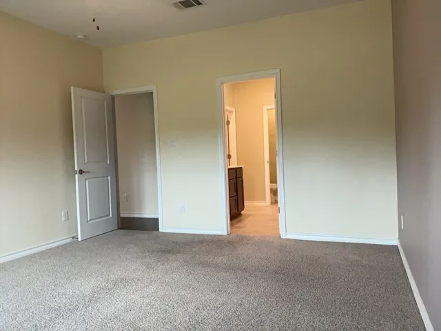 a view of a hallway to rooms