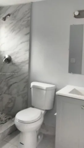 a white toilet sitting next to a bathroom sink