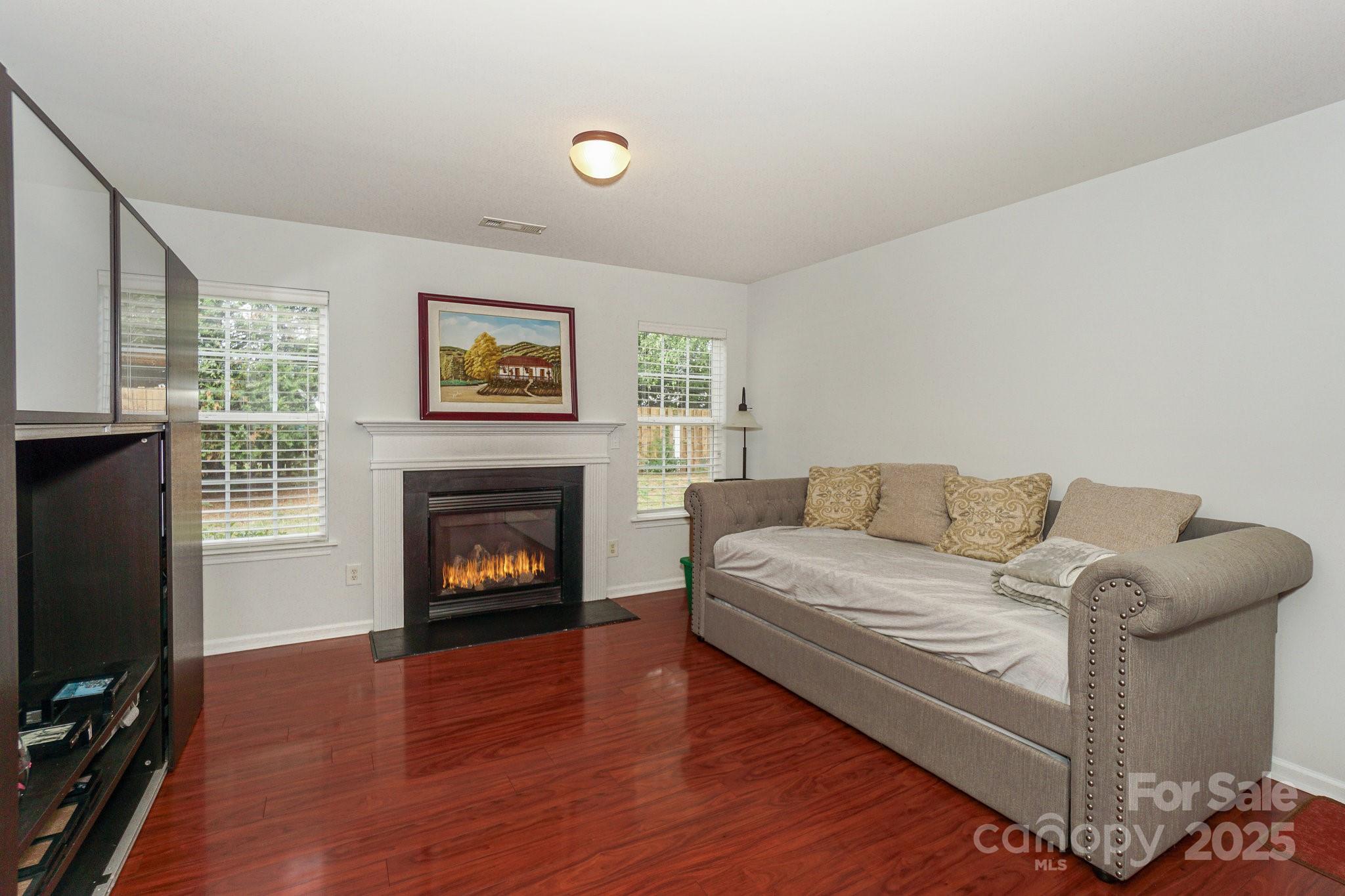 166 Glennallen Road Mooresville, NC 28115 - Photo 18 of 48 a living room with furniture a fireplace and a flat screen tv