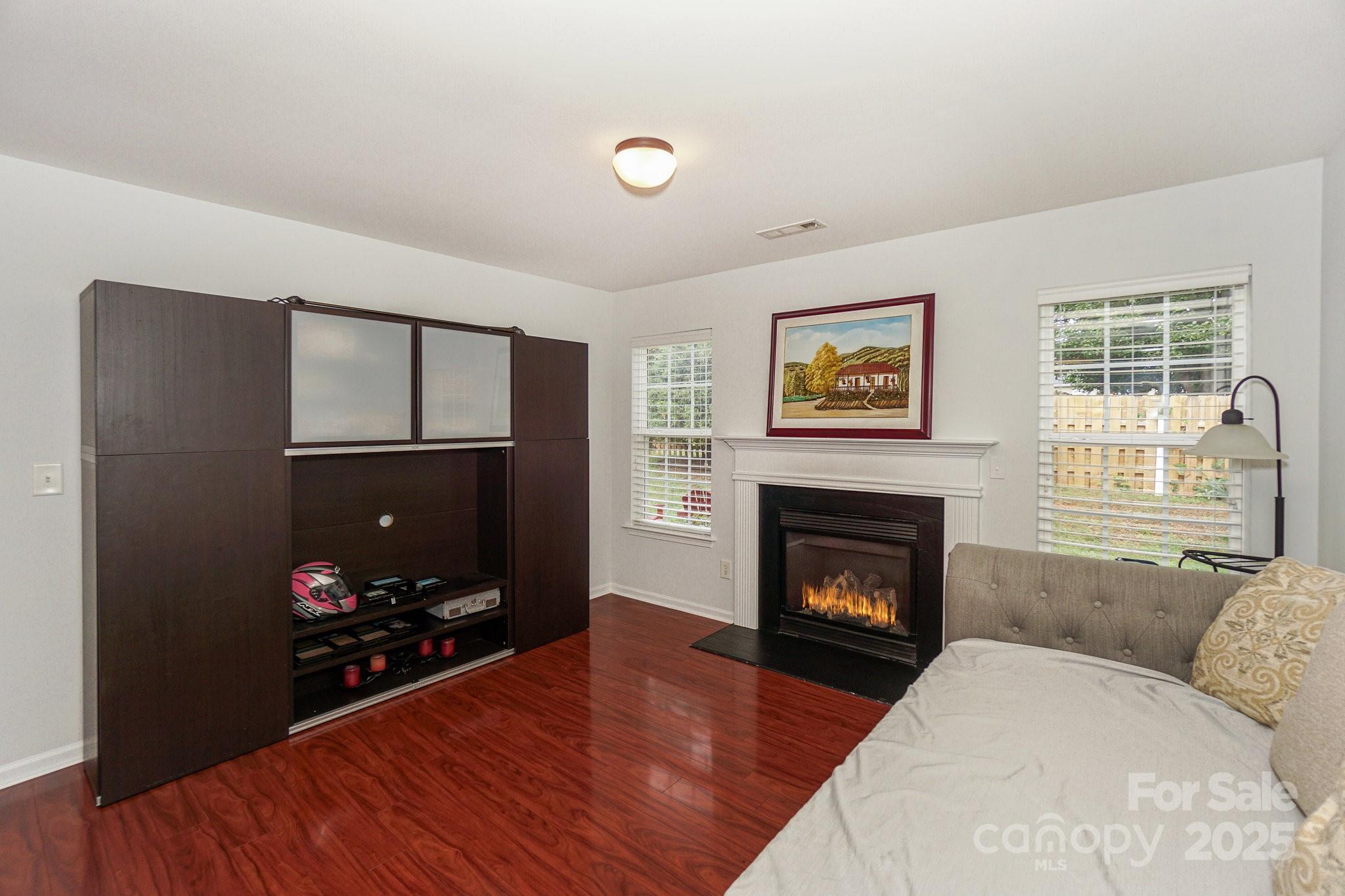 166 Glennallen Road Mooresville, NC 28115 - Photo 19 of 48 a living room with furniture a fireplace and a flat screen tv