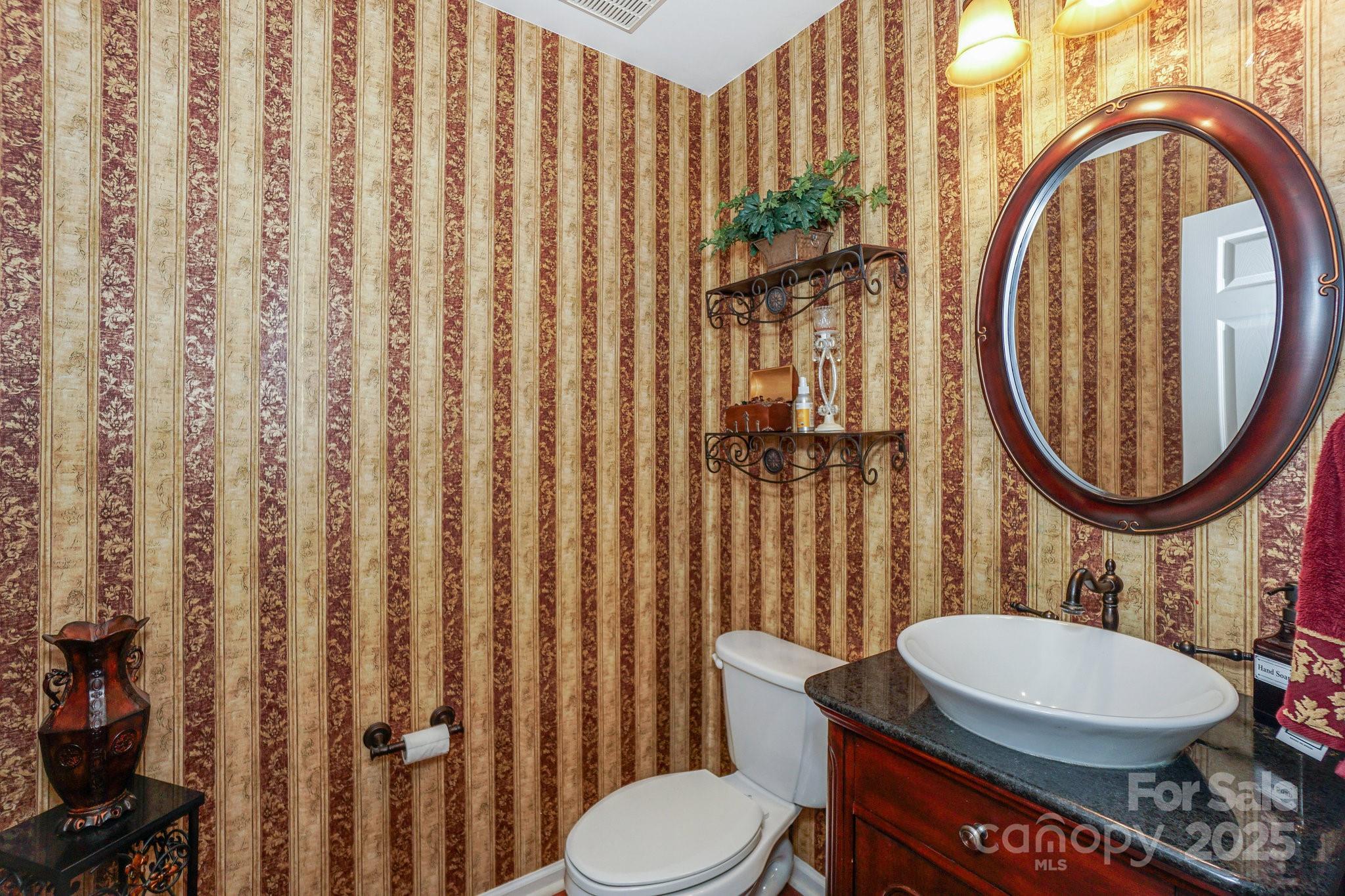 166 Glennallen Road Mooresville, NC 28115 - Photo 23 of 48 a bathroom with a toilet a sink and a mirror