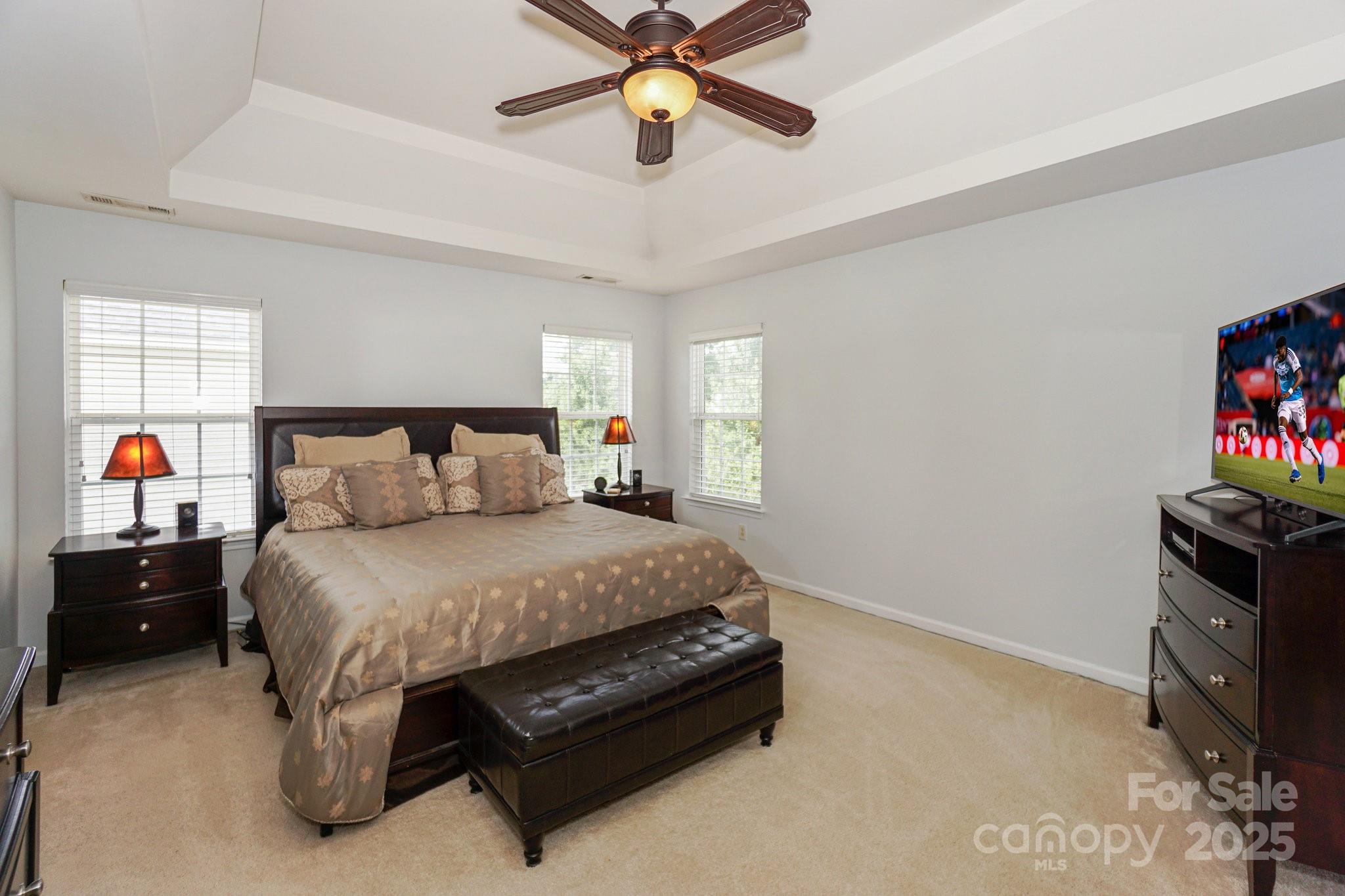 166 Glennallen Road Mooresville, NC 28115 - Photo 24 of 48 a bedroom with a bed and a chandelier