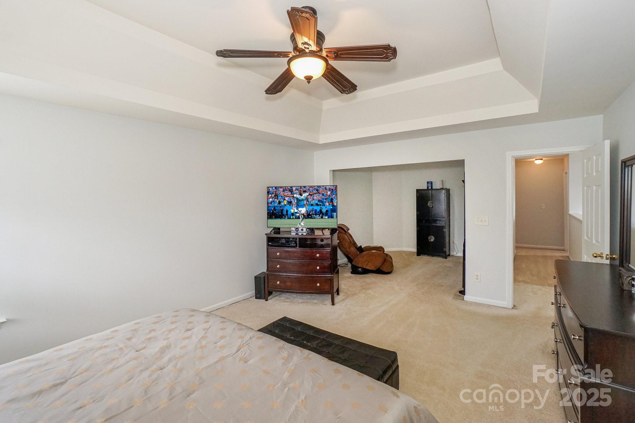 166 Glennallen Road Mooresville, NC 28115 - Photo 25 of 48 a bed room with a bed and a chandelier