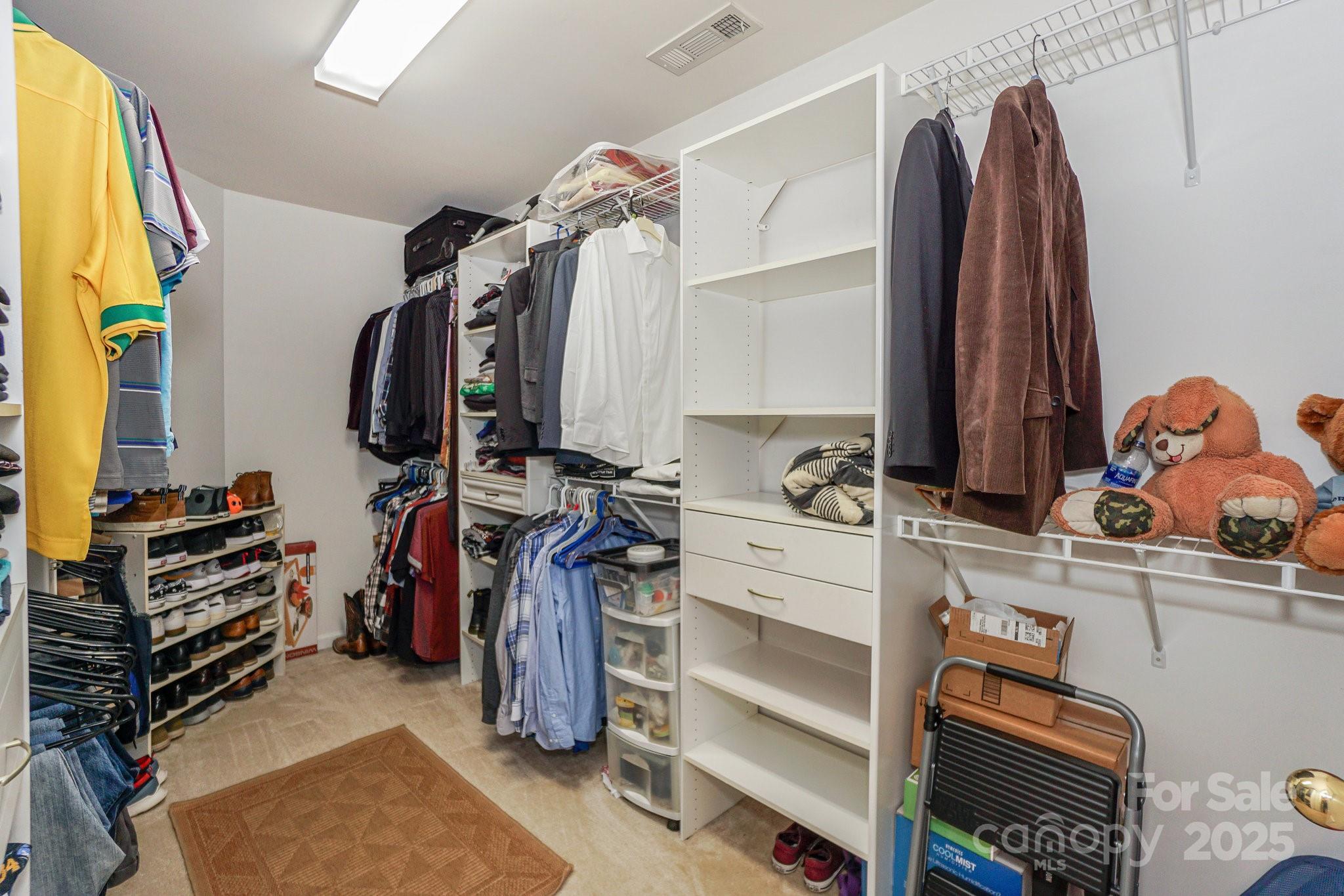 166 Glennallen Road Mooresville, NC 28115 - Photo 31 of 48 a view of walk in closet with clothes and shoes