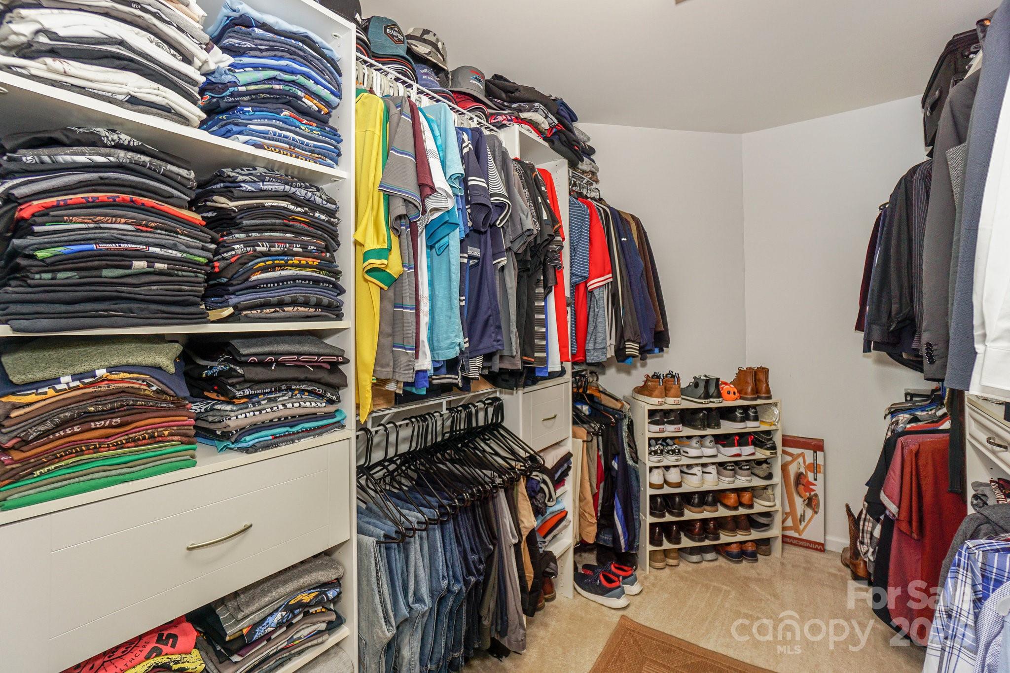 166 Glennallen Road Mooresville, NC 28115 - Photo 32 of 48 a view of walk in closet with clothes and shoes