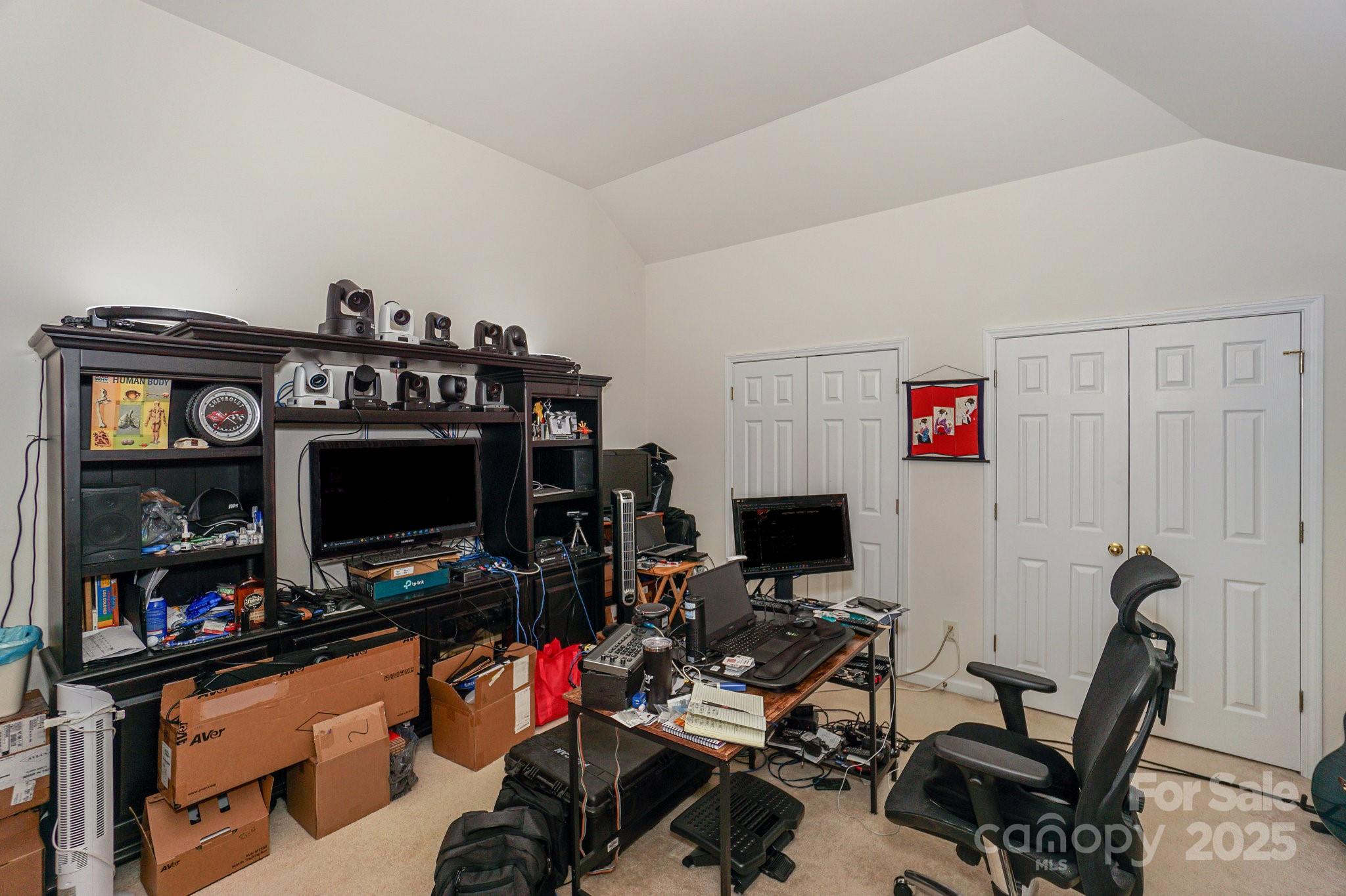 166 Glennallen Road Mooresville, NC 28115 - Photo 40 of 48 a view of a workspace with furniture and a flat screen tv