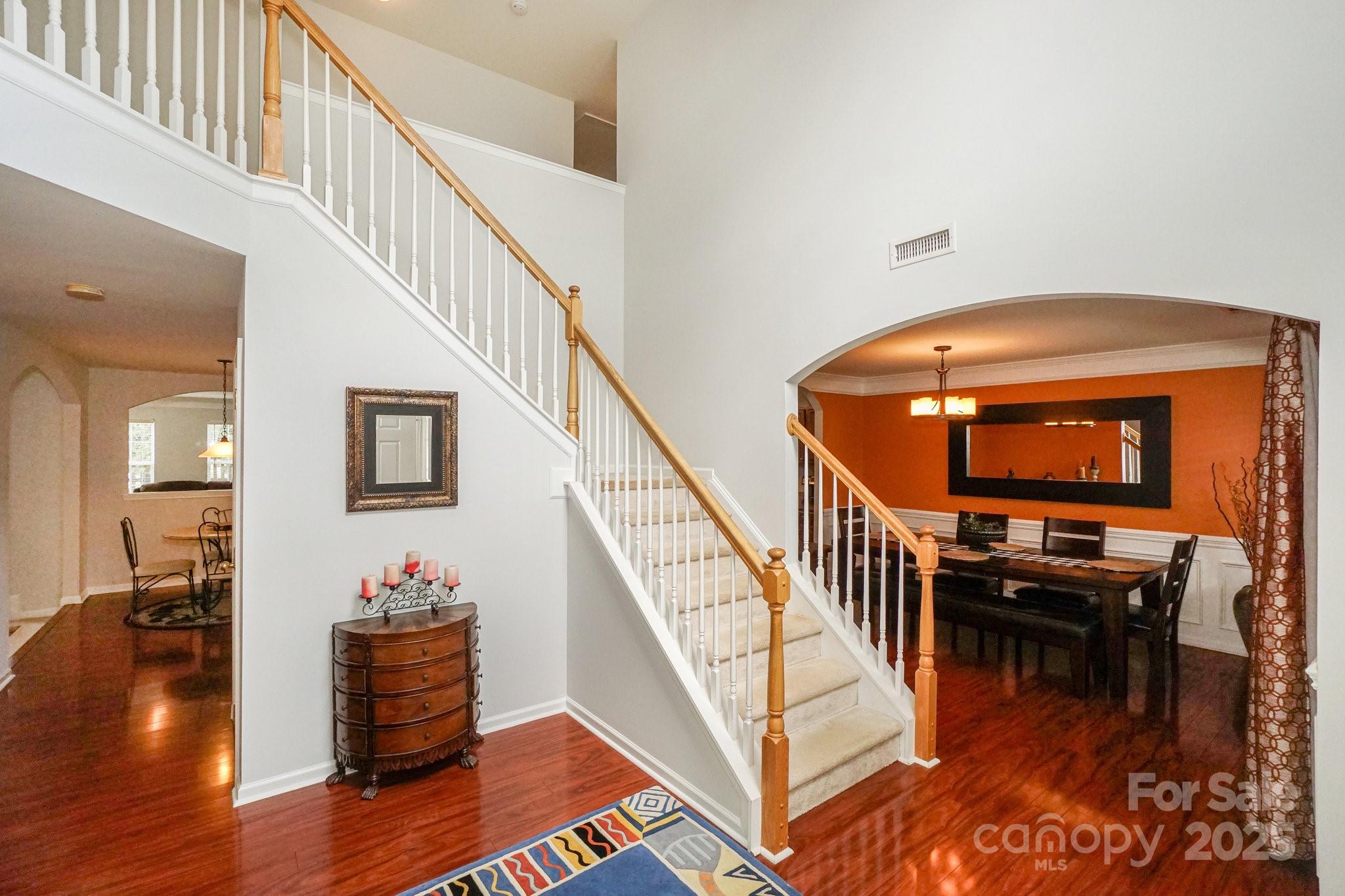 166 Glennallen Road Mooresville, NC 28115 - Photo 5 of 48 a dinning room with wooden floor and stairs