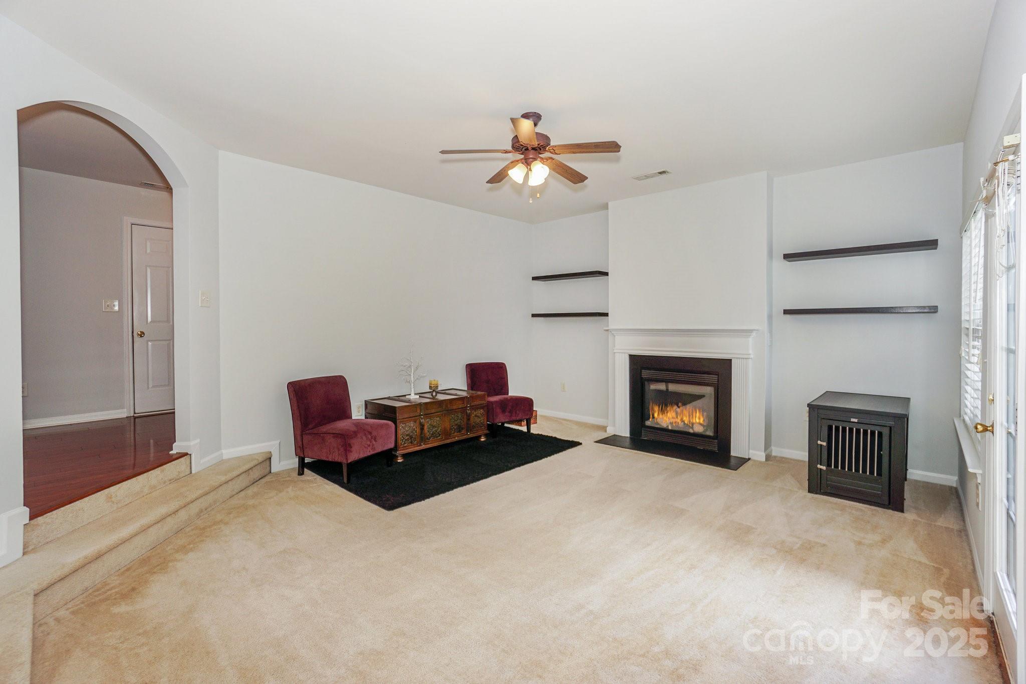 166 Glennallen Road Mooresville, NC 28115 - Photo 10 of 48 a living room with furniture a fireplace and a chandelier