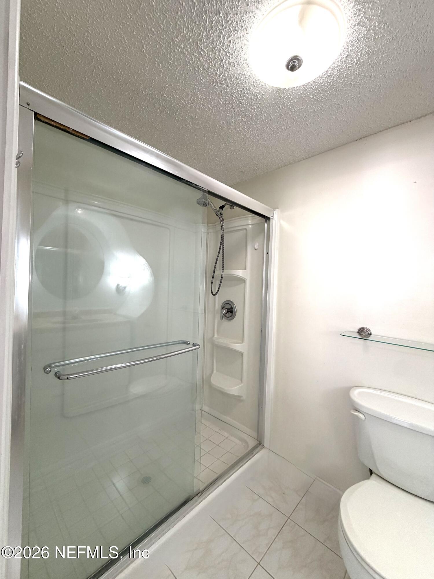 4127 Springwood Road Jacksonville, FL 32207 - Photo 21 of 63 a bathroom with a shower and a toilet
