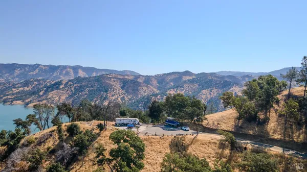 a view of a dry yard with mountains in the background