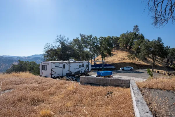 a view of a house with cars parked