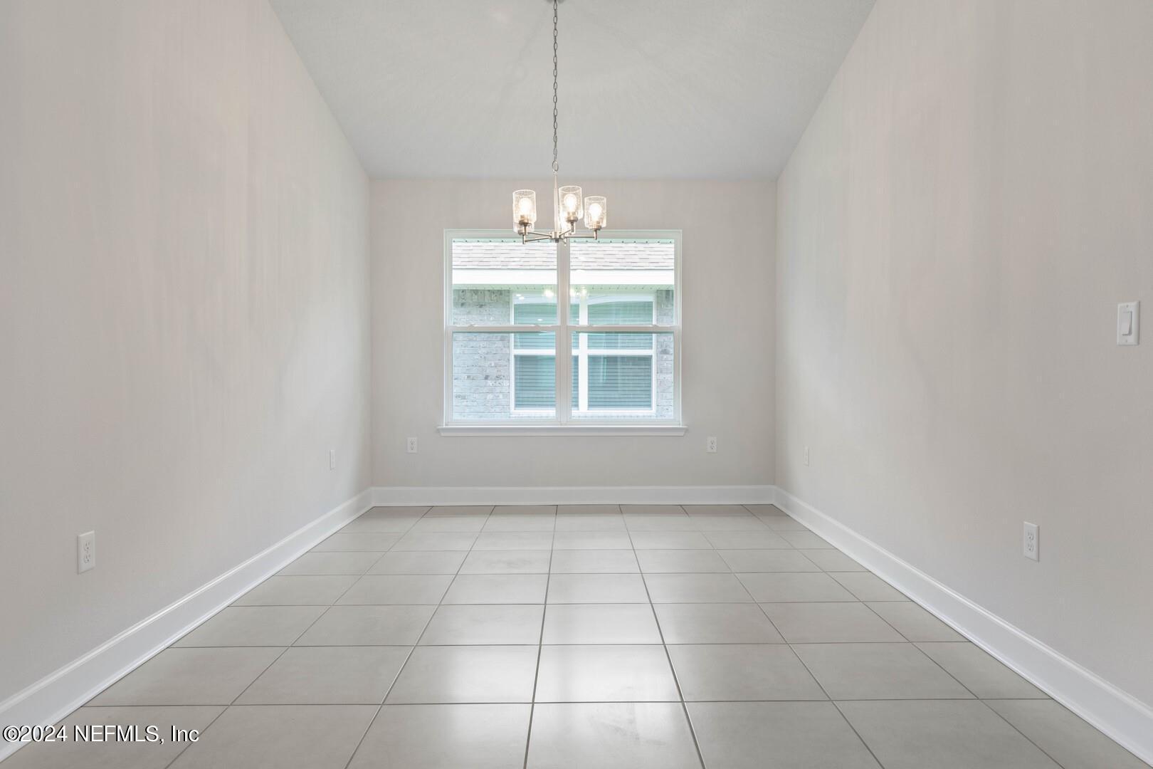 70 Rivertown Road Palm Coast, FL 32137 - Photo 11 of 25 an empty room with windows and entrance