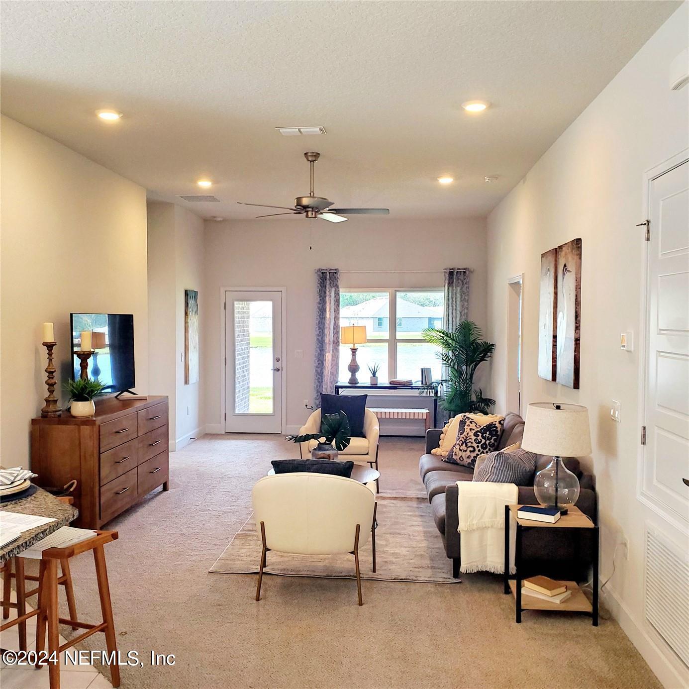 70 Rivertown Road Palm Coast, FL 32137 - Photo 12 of 25 a living room with furniture and a large window