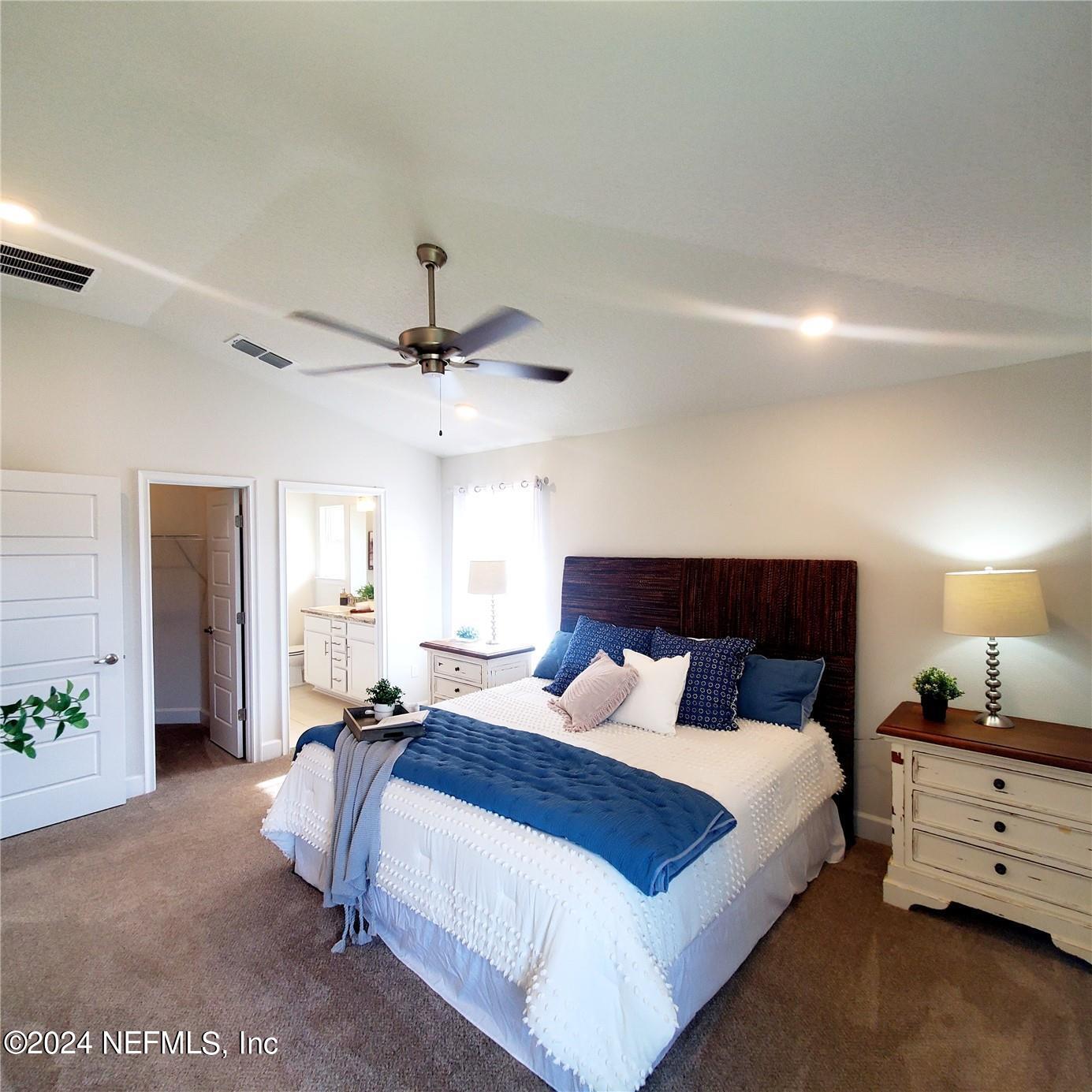 70 Rivertown Road Palm Coast, FL 32137 - Photo 16 of 25 a bedroom with a bed and wooden floor
