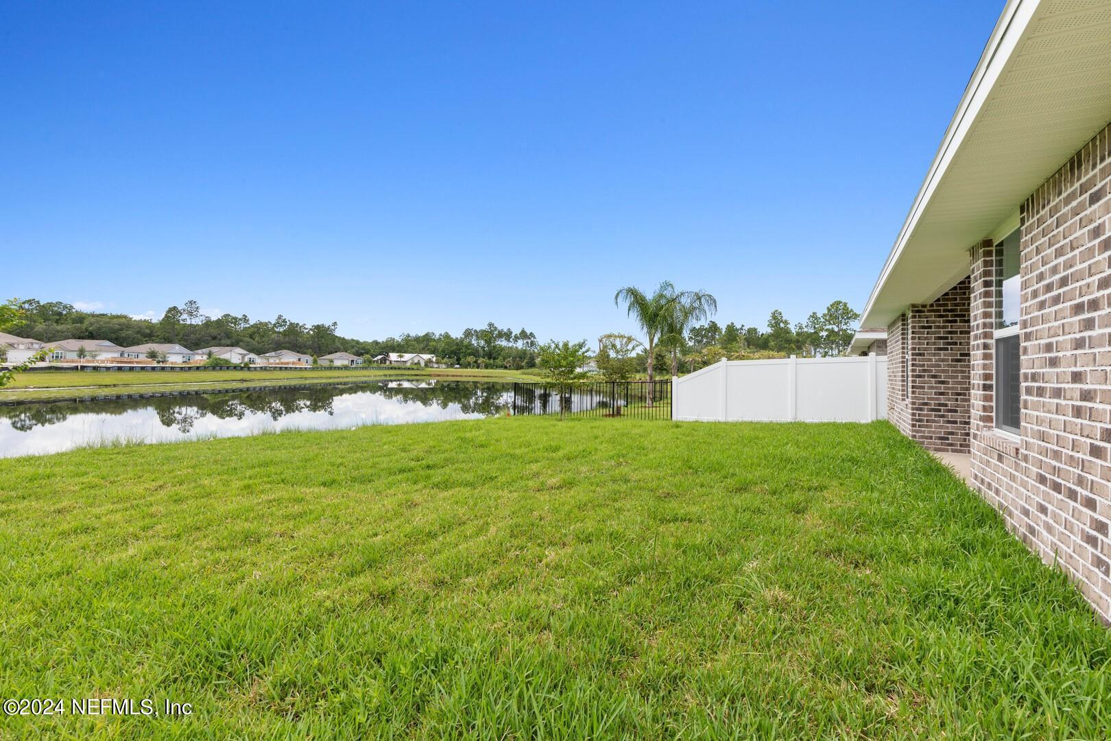 70 Rivertown Road Palm Coast, FL 32137 - Photo 20 of 25 a view of a yard with a house in the background