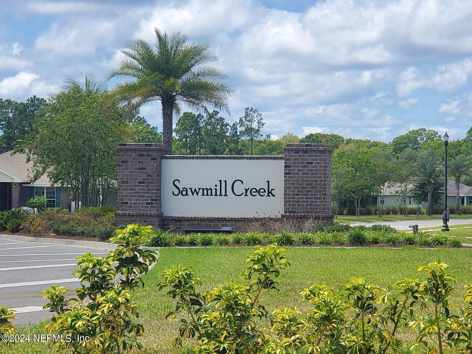 70 Rivertown Road Palm Coast, FL 32137 - Photo 22 of 25 a sign of golf club on a wall under a tree