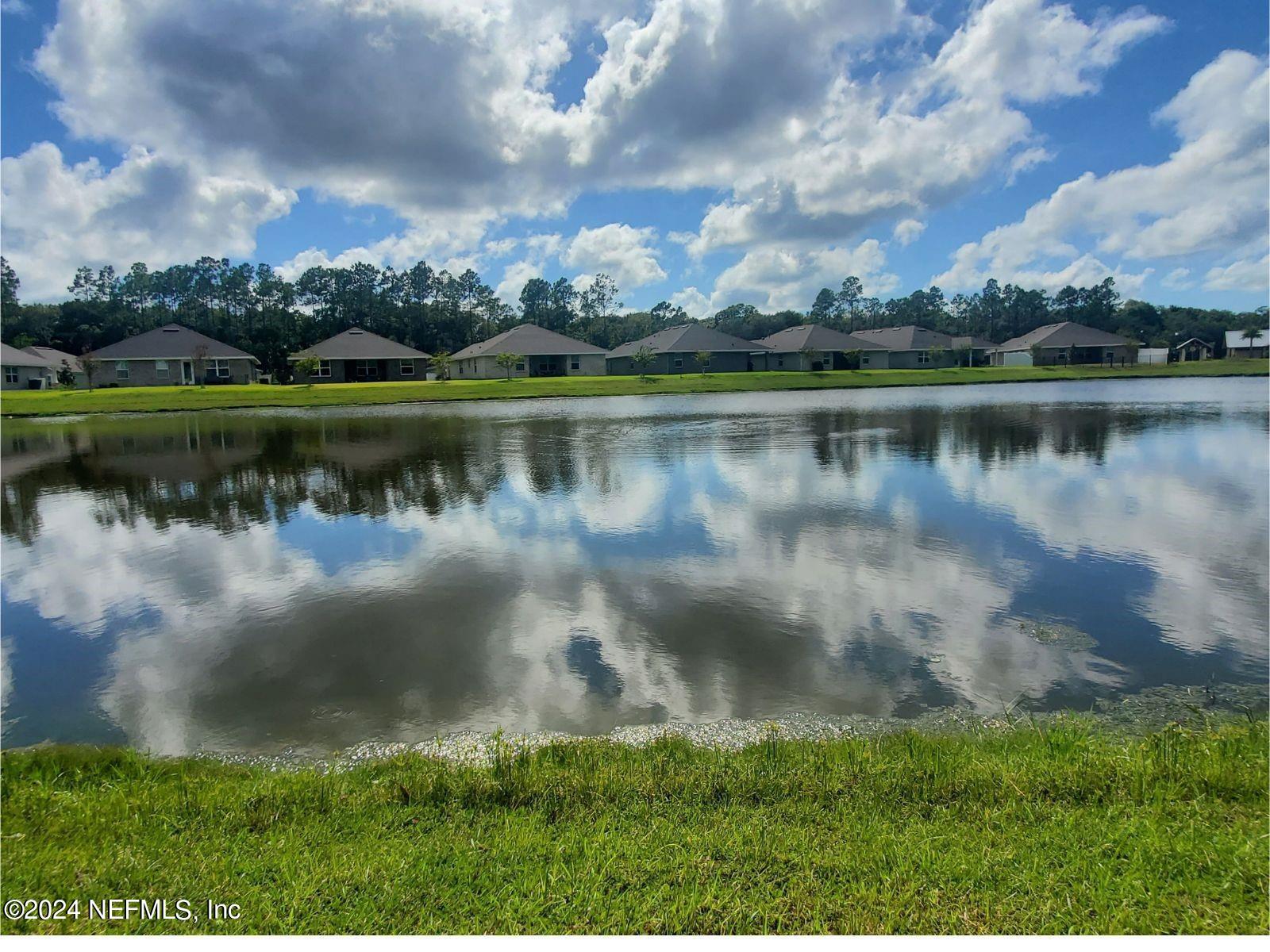70 Rivertown Road Palm Coast, FL 32137 - Photo 23 of 25 a view of a lake with a city view