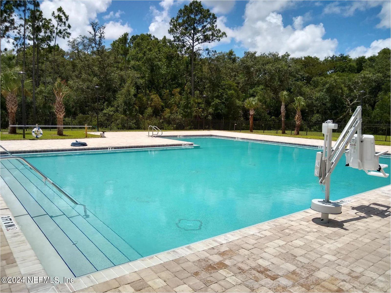70 Rivertown Road Palm Coast, FL 32137 - Photo 24 of 25 a view of a swimming pool with a yard