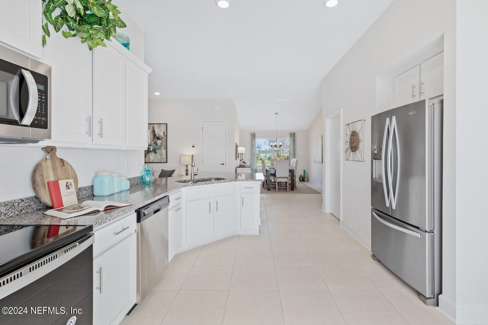 70 Rivertown Road Palm Coast, FL 32137 - Photo 4 of 25 a kitchen with stainless steel appliances a sink stove and refrigerator